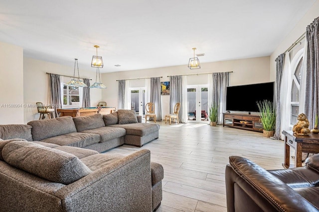 living room featuring light wood-type flooring and french doors