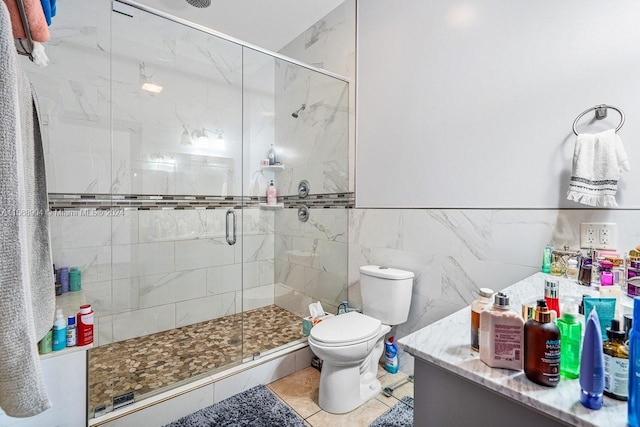 full bath featuring tile walls, a shower stall, toilet, and tile patterned floors