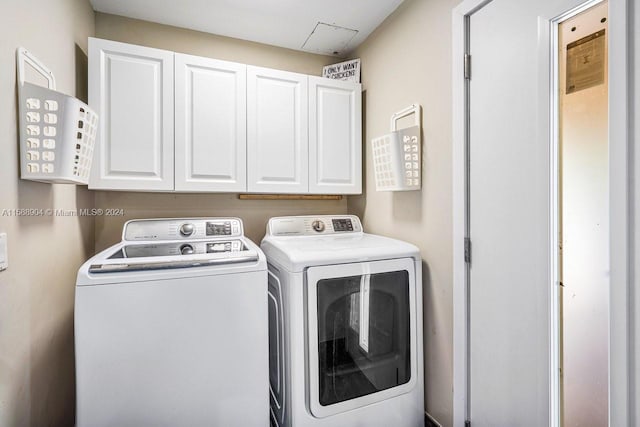 laundry area with washer and dryer and cabinet space