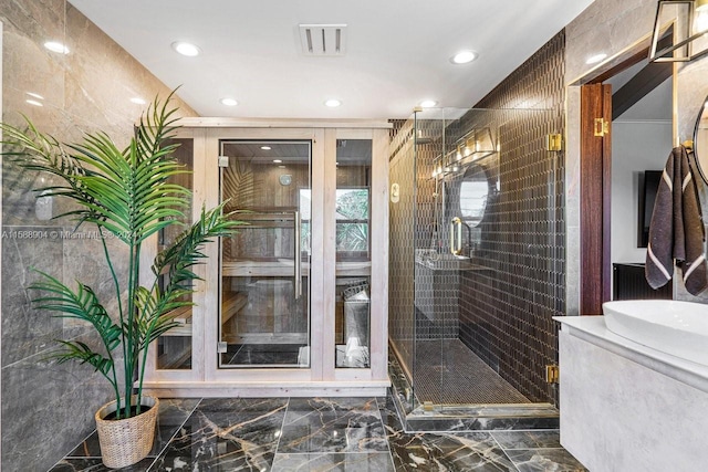 bathroom featuring marble finish floor, a stall shower, visible vents, and recessed lighting