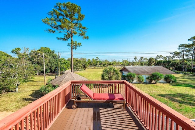 wooden deck featuring a lawn