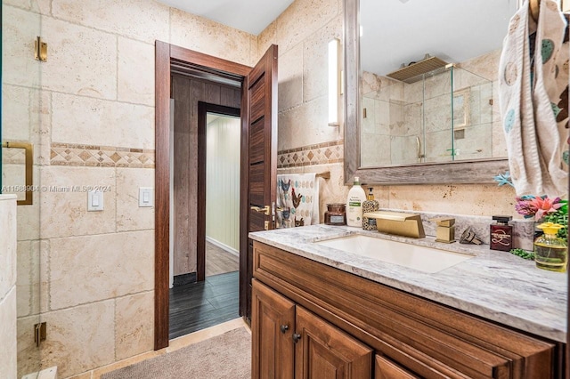 bathroom featuring a shower stall and vanity