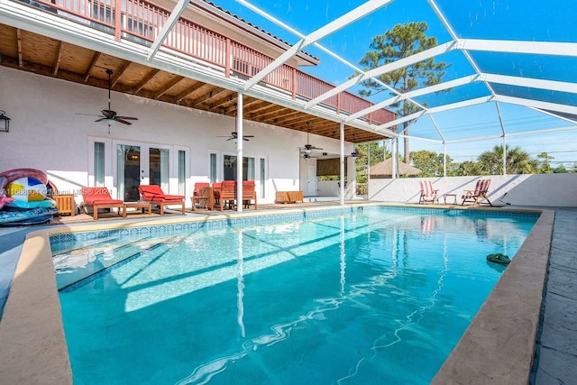 view of swimming pool featuring ceiling fan and a patio area