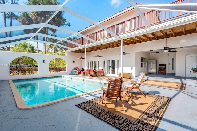 pool featuring french doors, a patio, a lanai, and ceiling fan