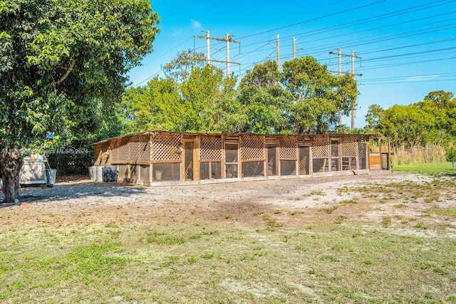 back of house with exterior structure and an outbuilding