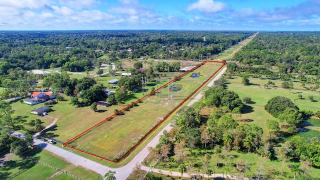 drone / aerial view featuring a rural view and a wooded view