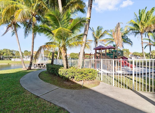 view of property's community featuring a water view, fence, and playground community