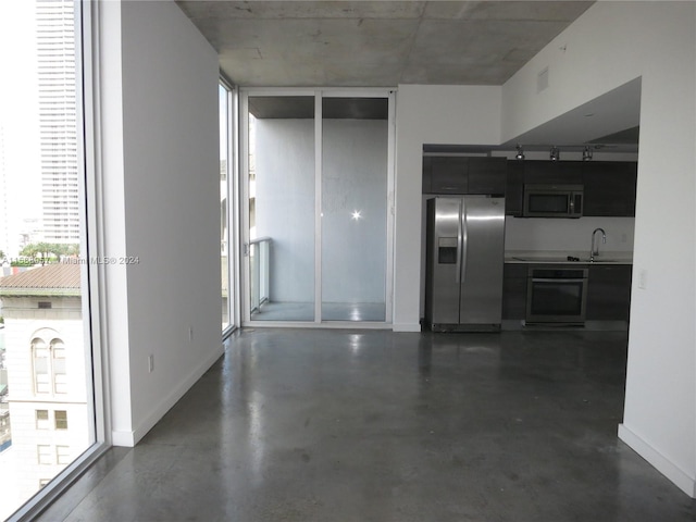 interior space featuring sink and a wall of windows