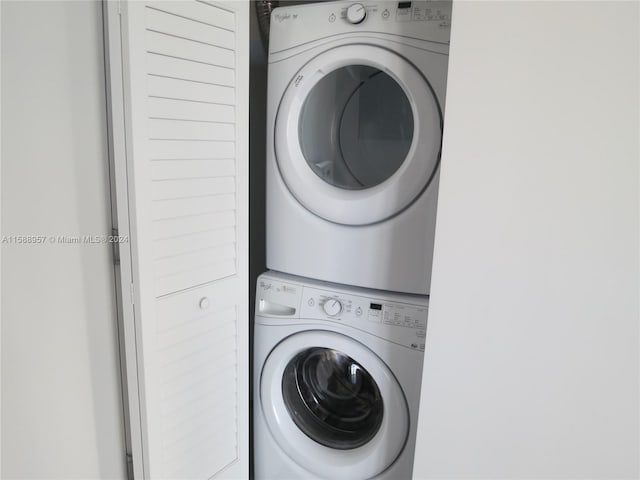 clothes washing area with stacked washer / drying machine