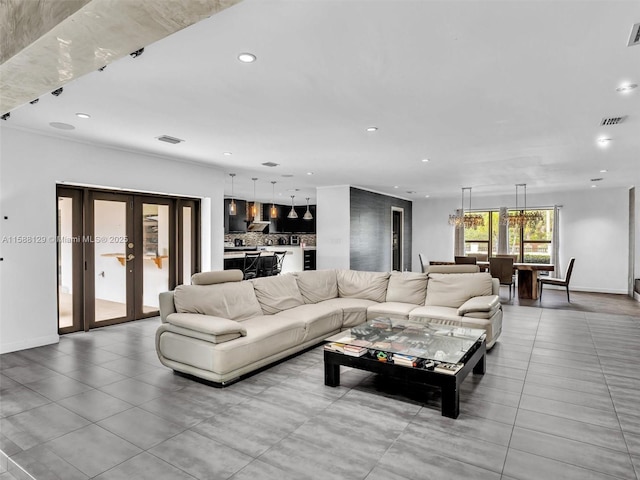 living area featuring recessed lighting, french doors, visible vents, and baseboards