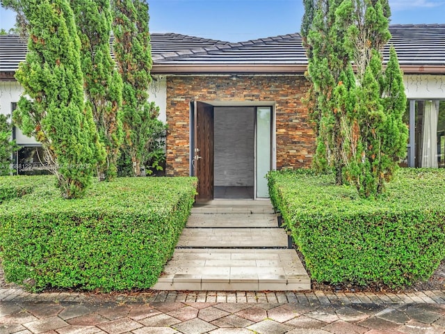 property entrance featuring a tiled roof