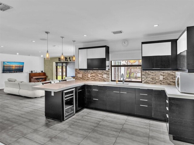 kitchen with stainless steel fridge with ice dispenser, light tile patterned floors, a kitchen island, pendant lighting, and backsplash