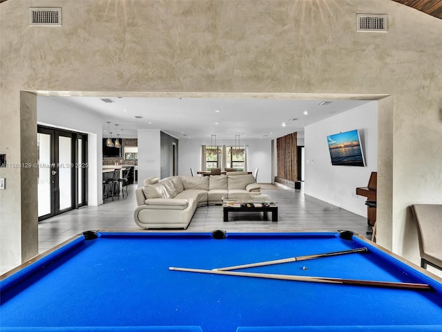 recreation room featuring light hardwood / wood-style flooring, pool table, and french doors