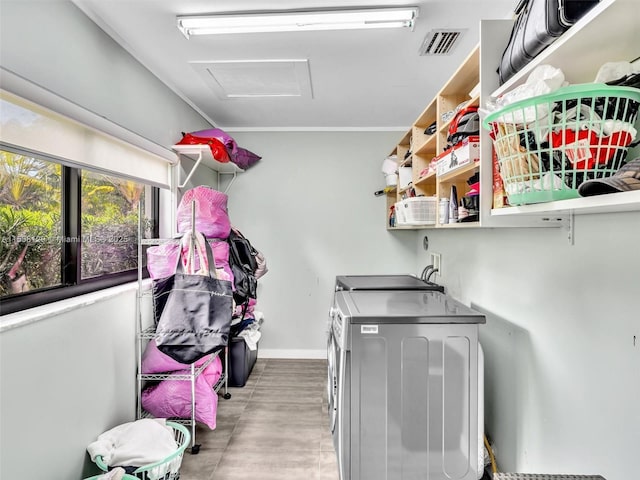 washroom with washer and clothes dryer, visible vents, attic access, laundry area, and baseboards