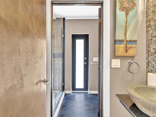 bathroom with a sink and baseboards