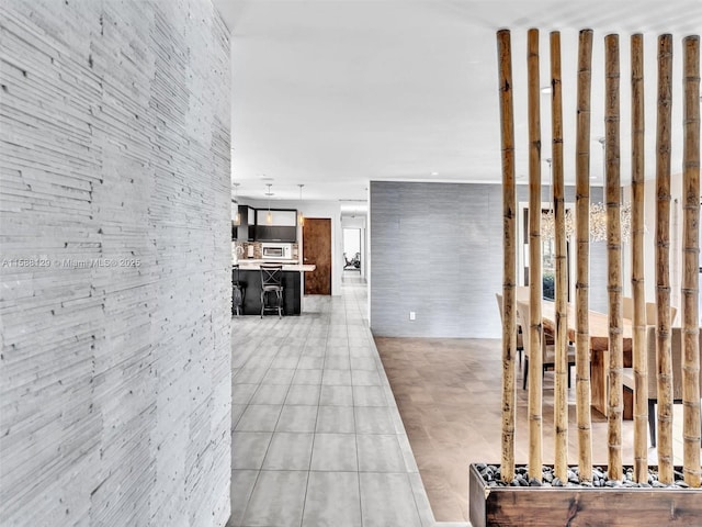 corridor featuring light tile patterned floors