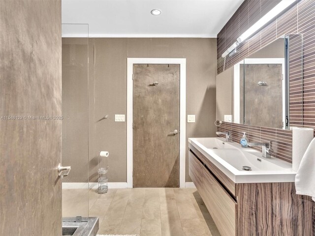 bathroom featuring tasteful backsplash, vanity, and a shower