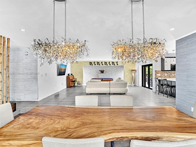 unfurnished dining area featuring tile patterned floors and an inviting chandelier