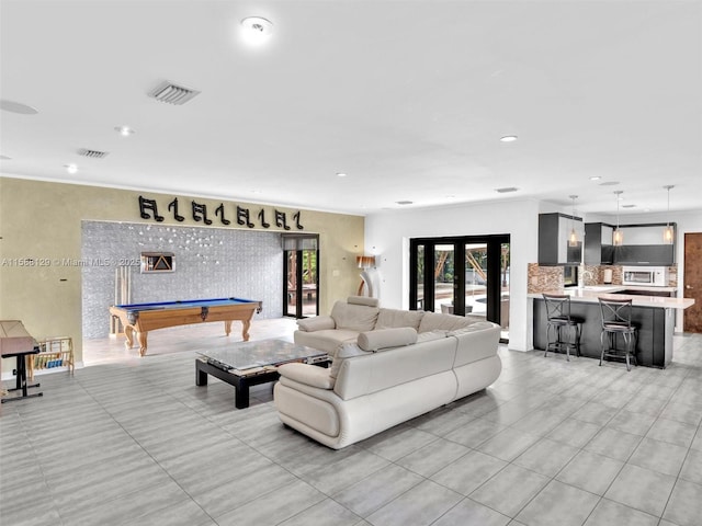 living room with french doors, billiards, and crown molding