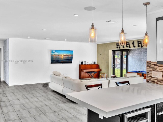 interior space featuring wine cooler, decorative light fixtures, and decorative backsplash