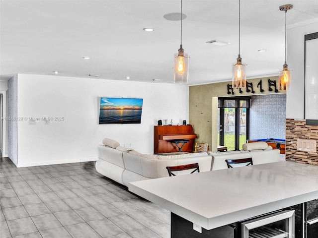 living area featuring beverage cooler, visible vents, baseboards, and recessed lighting