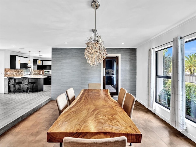 dining room with baseboards, recessed lighting, and an inviting chandelier