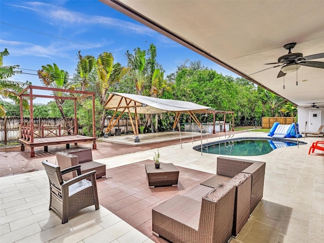 view of pool featuring an outdoor living space, a patio, and ceiling fan