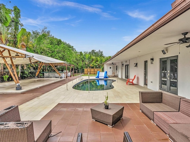 view of pool featuring ceiling fan, an outdoor hangout area, and a patio area