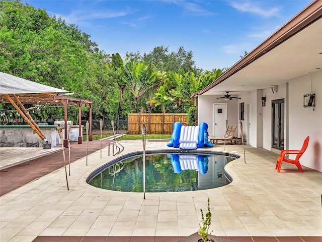 view of swimming pool featuring fence, a ceiling fan, a gazebo, a fenced in pool, and a patio area