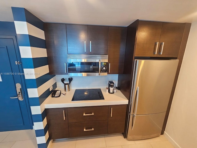 kitchen with sink, stainless steel appliances, backsplash, decorative light fixtures, and light tile patterned floors