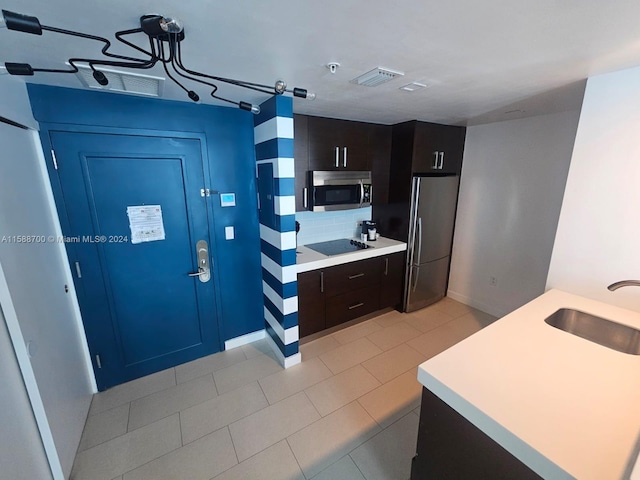 kitchen with light tile patterned floors, a breakfast bar area, stainless steel appliances, and kitchen peninsula