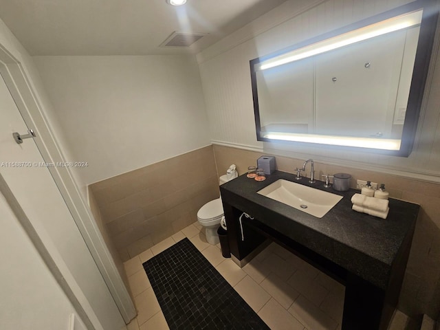 bathroom featuring tile patterned flooring, vanity, and plus walk in shower