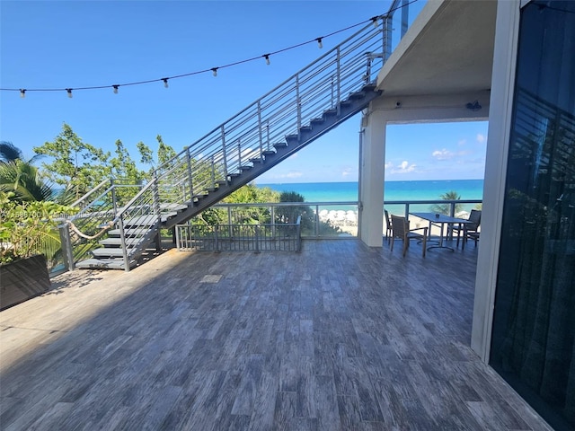 wooden terrace featuring a water view