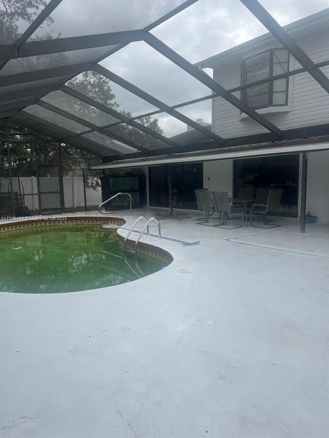 view of pool with a patio and a lanai