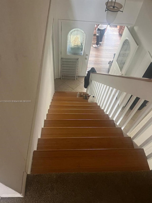 stairs with tile patterned floors