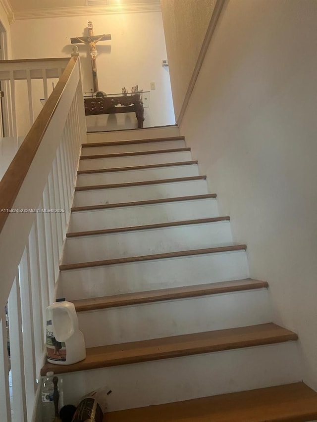 staircase with crown molding