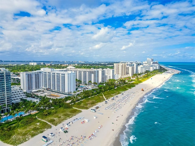 drone / aerial view featuring a water view and a beach view