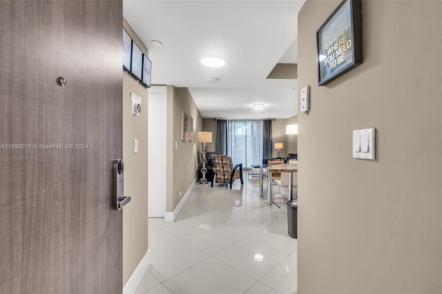 hall with light tile patterned floors