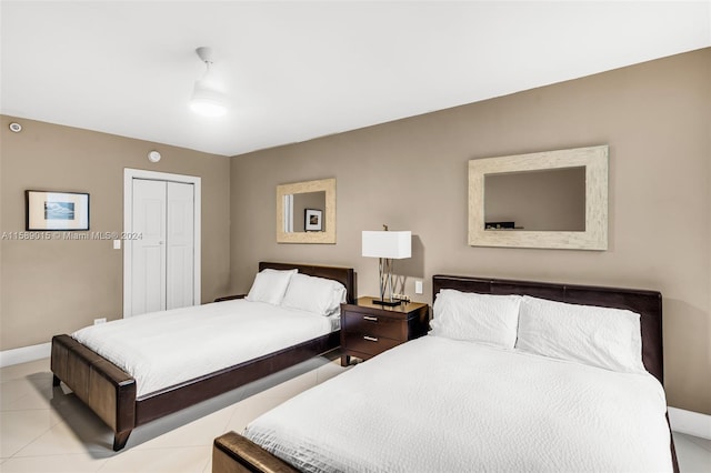 bedroom featuring light tile patterned floors and a closet