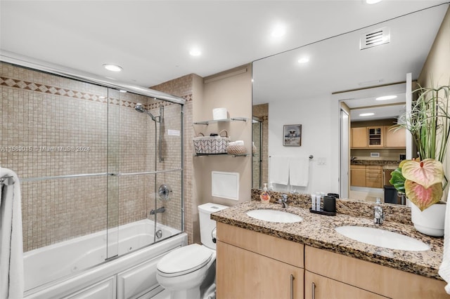 full bathroom with toilet, vanity, and combined bath / shower with glass door