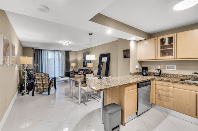 kitchen featuring kitchen peninsula, light brown cabinets, light tile patterned floors, and stainless steel dishwasher