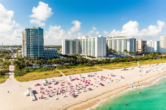 drone / aerial view with a water view and a view of the beach