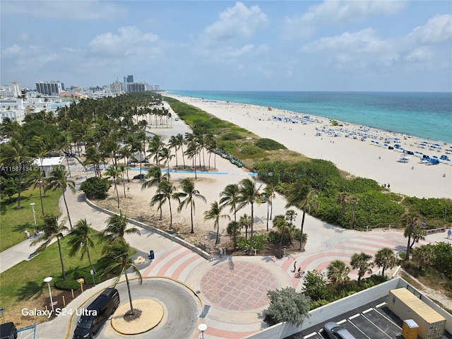 birds eye view of property featuring a beach view and a water view