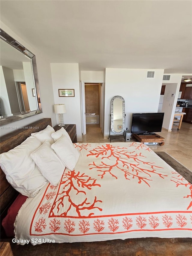 bedroom with ensuite bathroom and wood-type flooring