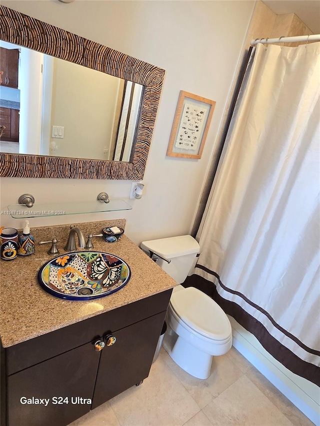 bathroom featuring vanity, toilet, and tile floors