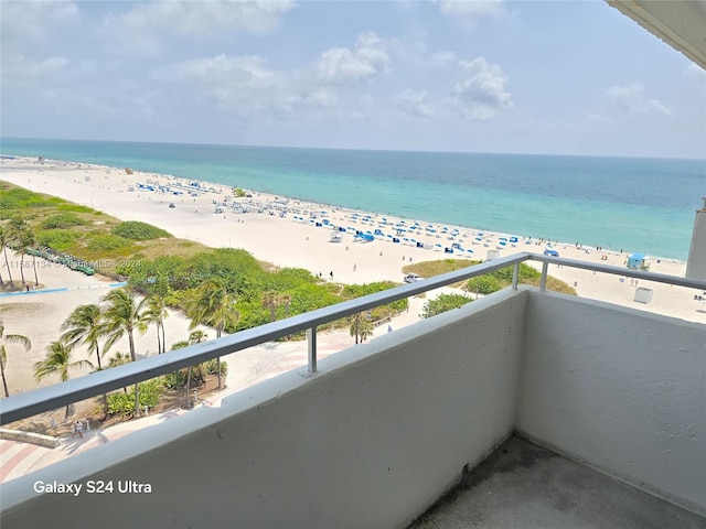 balcony featuring a water view and a view of the beach