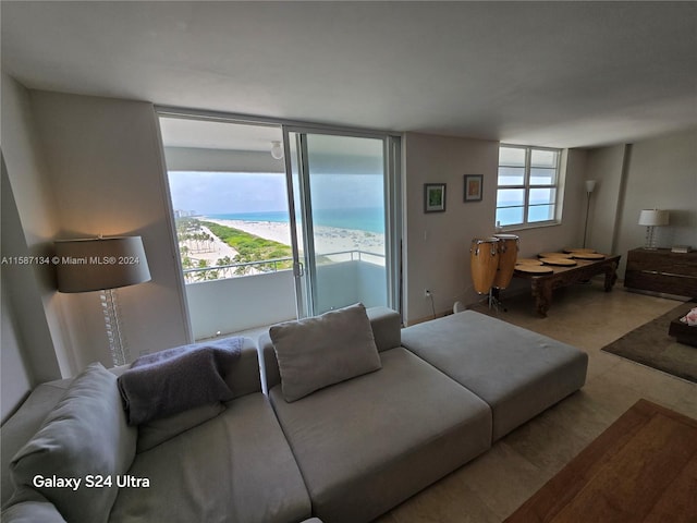 living room featuring a water view and tile floors