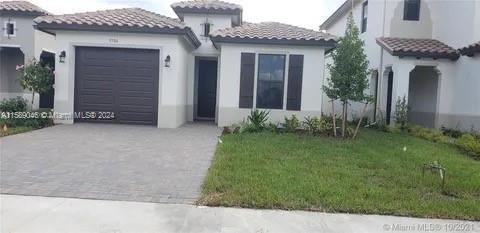 mediterranean / spanish house with a front yard and a garage