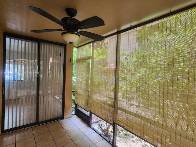 unfurnished sunroom with ceiling fan