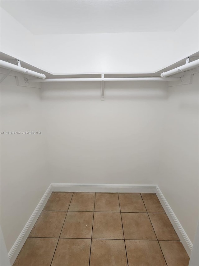 walk in closet with tile patterned floors